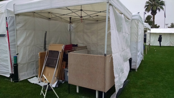 partially set up booth, with rain